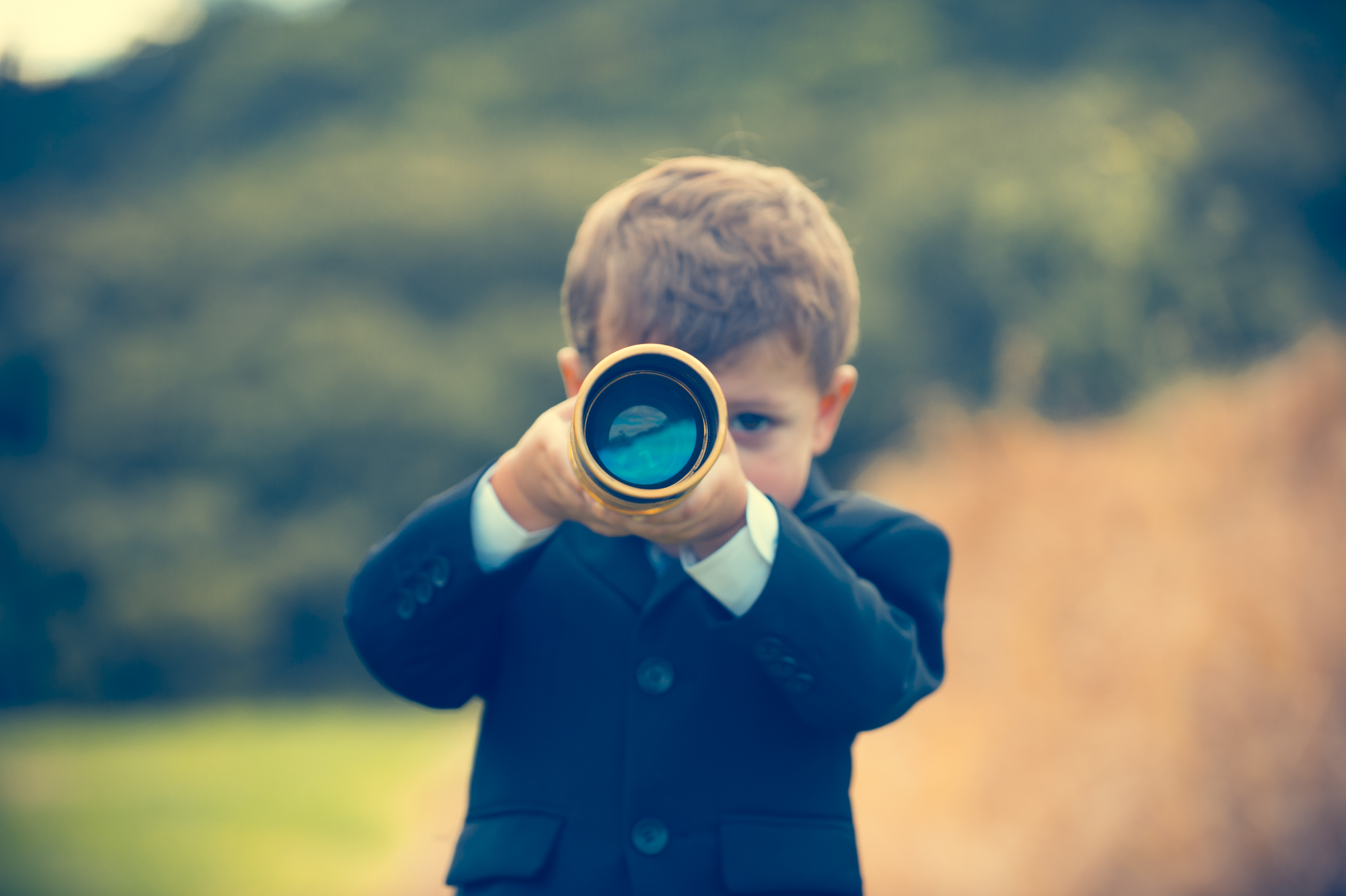 Young child looking through telescope